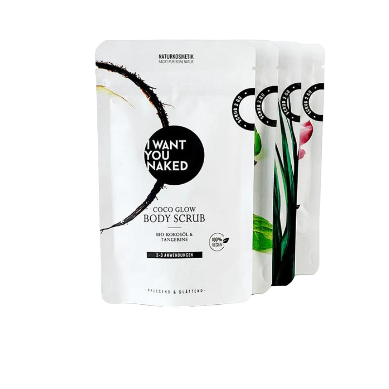 Vier Packungen Naturkosmetik von 'I Want You Naked', darunter ein Body Scrub mit Bio-Kokosöl und Mandarine.